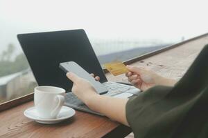 online payment, young woman holding credit card and touching on smartphone screen, copy space photo