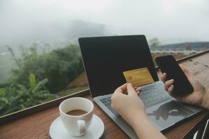 online payment, young woman holding credit card and touching on smartphone screen, copy space photo