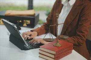 Business and lawyers discussing contract papers with brass scale on desk in office. Law, legal services, advice, justice and law concept picture with film grain effect photo