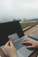 online payment, young woman holding credit card and touching on smartphone screen, copy space photo