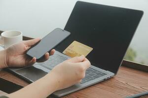 online payment, young woman holding credit card and touching on smartphone screen, copy space photo