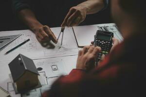 Engineer Teamwork Meeting, Drawing working on blueprint meeting for project working with partner on model building and engineering tools in working site, Construction and structure concept. photo