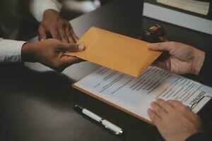 Business and lawyers discussing contract papers with brass scale on desk in office. Law, legal services, advice, justice and law concept picture with film grain effect photo