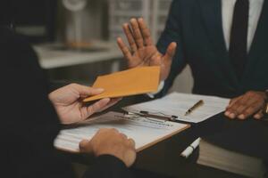 Business and lawyers discussing contract papers with brass scale on desk in office. Law, legal services, advice, justice and law concept picture with film grain effect photo