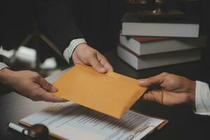 Business and lawyers discussing contract papers with brass scale on desk in office. Law, legal services, advice, justice and law concept picture with film grain effect photo