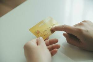 Woman hands holding and using cradit card for shopping online. photo