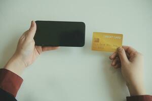 Woman hands holding and using cradit card for shopping online. photo