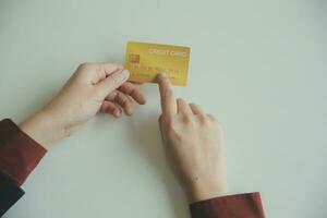 Woman hands holding and using cradit card for shopping online. photo