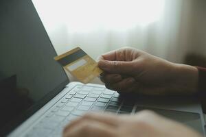 Woman hands holding and using cradit card for shopping online. photo