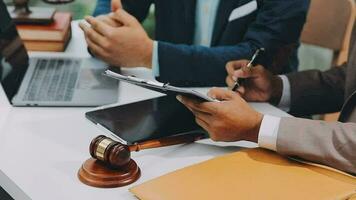 Justice and law concept.Male judge in a courtroom with the gavel, working with, computer and docking keyboard, eyeglasses, on table in morning light video