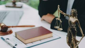 Justice and law concept.Male judge in a courtroom with the gavel, working with, computer and docking keyboard, eyeglasses, on table in morning light video