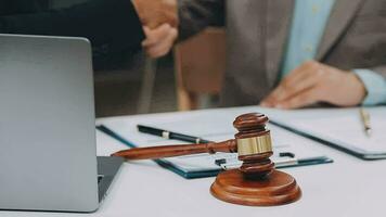 Justice and law concept.Male judge in a courtroom with the gavel, working with, computer and docking keyboard, eyeglasses, on table in morning light video