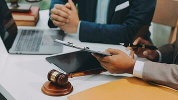 Justice and law concept.Male judge in a courtroom with the gavel, working with, computer and docking keyboard, eyeglasses, on table in morning light video