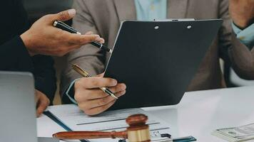 Justice and law concept.Male judge in a courtroom with the gavel, working with, computer and docking keyboard, eyeglasses, on table in morning light video