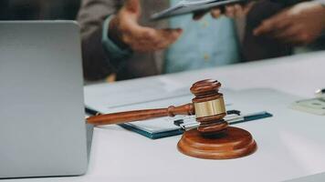 Justice and law concept.Male judge in a courtroom with the gavel, working with, computer and docking keyboard, eyeglasses, on table in morning light video