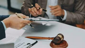 Justice and law concept.Male judge in a courtroom with the gavel, working with, computer and docking keyboard, eyeglasses, on table in morning light video