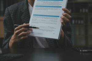 Business and lawyers discussing contract papers with brass scale on desk in office. Law, legal services, advice, justice and law concept picture with film grain effect photo