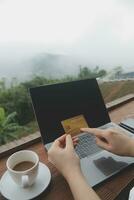 online payment, young woman holding credit card and touching on smartphone screen, copy space photo