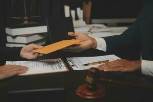 Business and lawyers discussing contract papers with brass scale on desk in office. Law, legal services, advice, justice and law concept picture with film grain effect photo