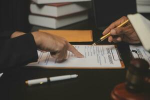 Business and lawyers discussing contract papers with brass scale on desk in office. Law, legal services, advice, justice and law concept picture with film grain effect photo