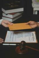 Business and lawyers discussing contract papers with brass scale on desk in office. Law, legal services, advice, justice and law concept picture with film grain effect photo