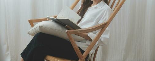 Happy freelance asian woman work on tablet on the hotel bed on travel trip. photo