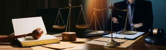 Business and lawyers discussing contract papers with brass scale on desk in office. Law, legal services, advice, justice and law concept picture with film grain effect photo
