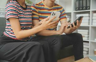 Young couple use credit card for online shopping on internet website at home. Number on the credit card is mock up. No personal information shown on the credit card. Online business shopping concept. photo