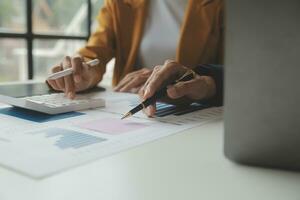 Accounting businessman working on laptop computer and analyzing real estate investment data, Financial and tax systems concept. photo