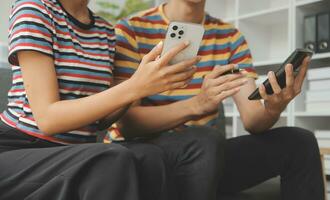 Young couple use credit card for online shopping on internet website at home. Number on the credit card is mock up. No personal information shown on the credit card. Online business shopping concept. photo