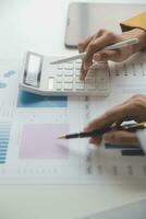 Accounting businessman working on laptop computer and analyzing real estate investment data, Financial and tax systems concept. photo