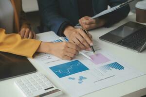 Financial Business team present. Business man hands hold documents with financial statistic stock photo, discussion, and analysis report data the charts and graphs. Finance Financial concept photo