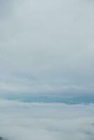 Mountain range with visible silhouettes through the morning blue fog. photo