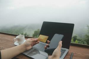 online payment, young woman holding credit card and touching on smartphone screen, copy space photo