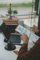 Business and lawyers discussing contract papers with brass scale on desk in office. Law, legal services, advice, justice and law concept picture with film grain effect photo