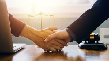 Businessman shaking hands to seal a deal with his partner lawyers or attorneys discussing a contract agreement photo