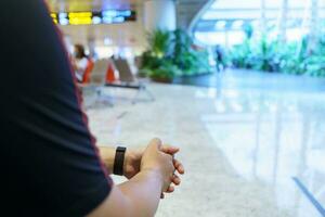 Man waiting for flight in airport departure area at airport waiting the flight photo