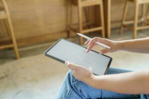 Woman holding blank screen on digital tablet device. technology background tablet with blank empty screen. photo