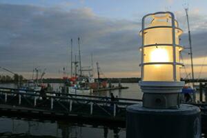 Lamp and fishing boats in Richmond, British Columbia, Canada photo