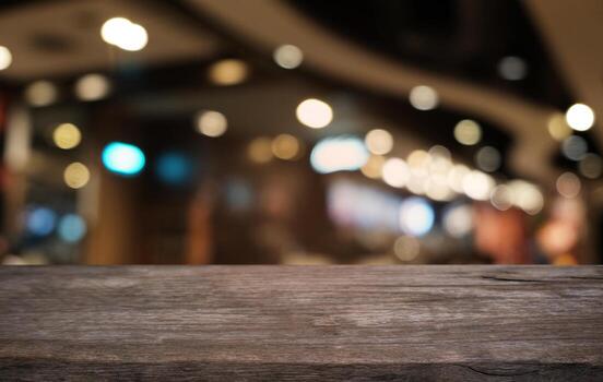 Empty dark wooden table in front of abstract blurred bokeh background of restaurant . can be used for display or montage your products.Mock up for space. photo