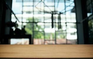 Empty wooden table in front of abstract blurred background of coffee shop . can be used for display or montage your products.Mock up for display of product photo