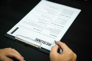 Examiner reading a resume during job interview at office Business and human resources concept. photo