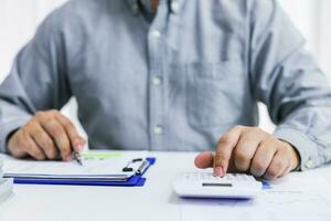 Businessman checking bills. taxes bank account balance and calculating annual financial statements of company. Accounting Audit Concept. photo