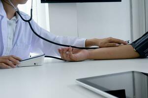 Doctor checking old woman patient arterial blood pressure. Health care photo