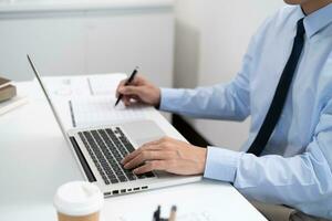 Business man working by using laptop computer Hands typing on a keyboard. Professional investor working new start up project. business planning in office. Technology business photo