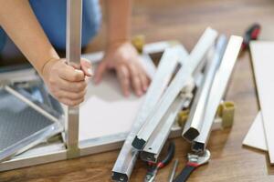 Asian Woman self repairs furniture renovation using equipment to diy repairing furniture sitting on the floor at home photo