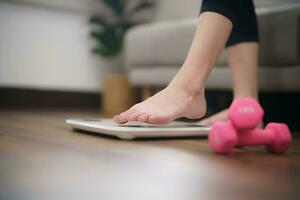 Fat diet and scale feet standing on electronic scales for weight control. Measurement instrument in kilogram for a diet control photo