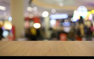 Empty wooden table in front of abstract blurred background of coffee shop . can be used for display or montage your products.Mock up for display of product photo