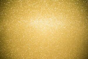 Gold glitters background. shimmering blur spot lights Bokeh Shiny gold light background. photo