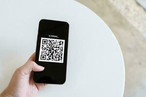 Qr code payment. E wallet. Man scanning tag accepted generate digital pay without money.scanning QR code online shopping cashless payment and verification technology concept. photo